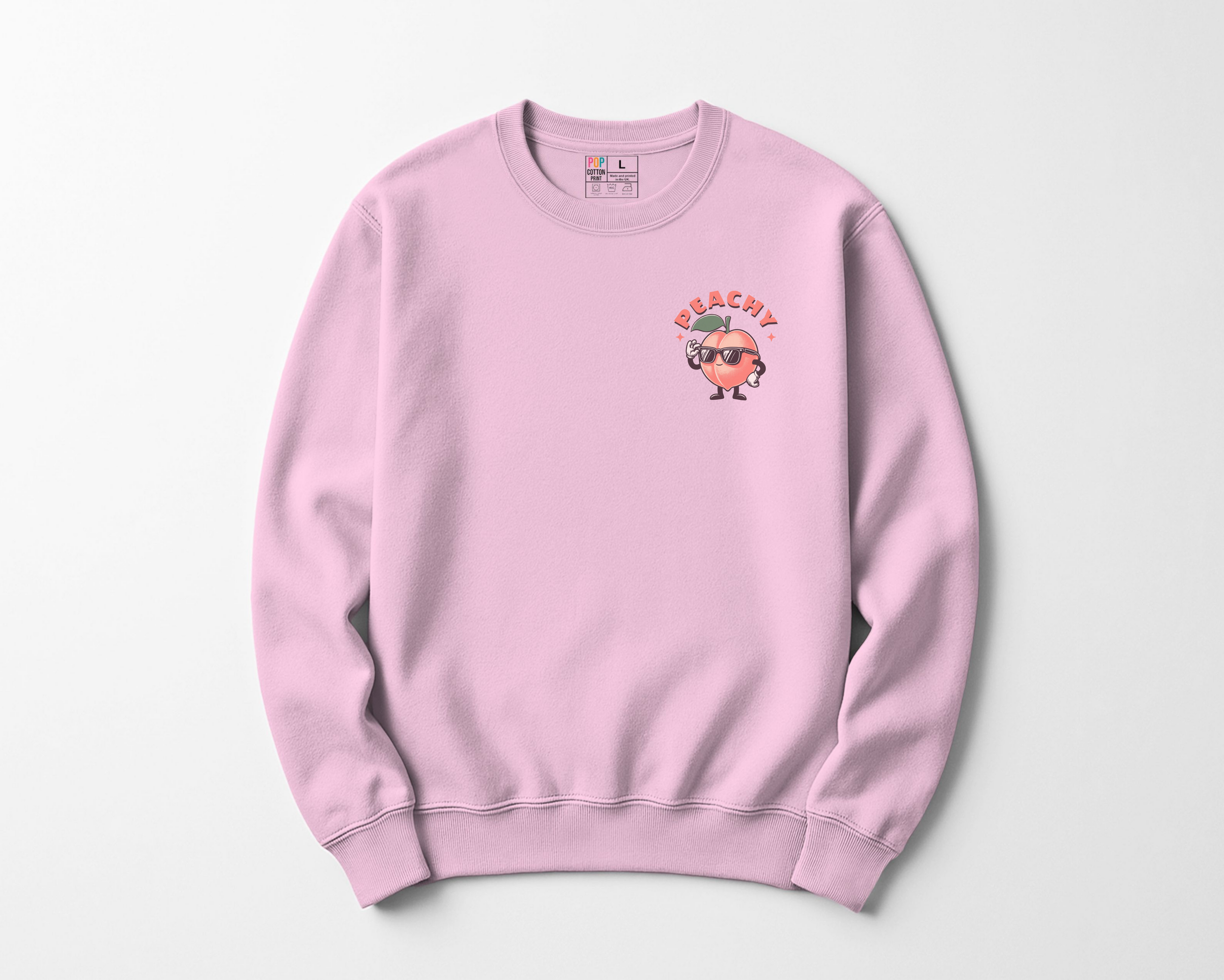 Pink sweatshirt with a Peachy character and text 